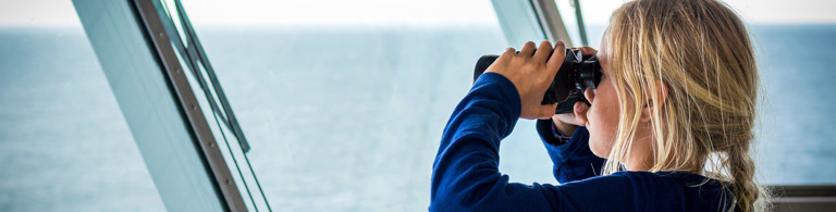 EN-lost-and-found-request-girl-with-binoculars-window